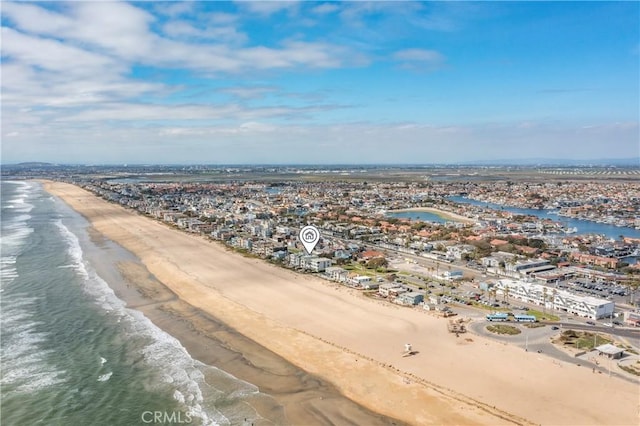 drone / aerial view featuring a water view and a view of the beach