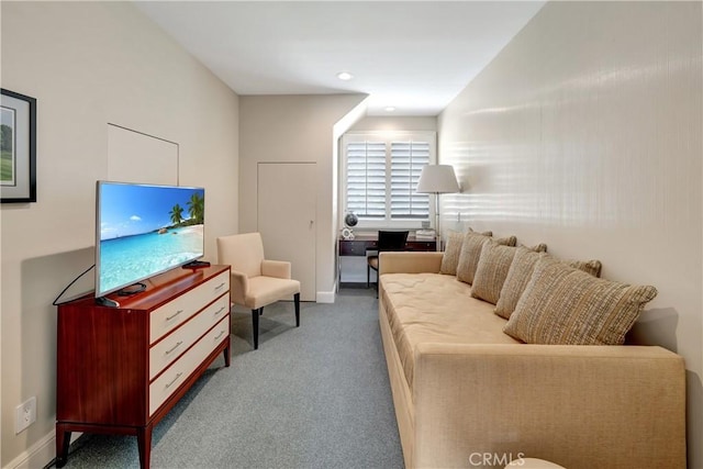 living area with baseboards and carpet floors