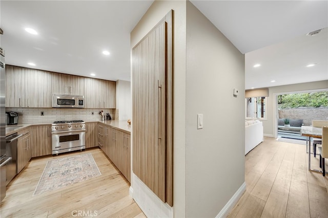 247 Calliope St, Laguna Beach, CA 92651 - kitchen featuring appliances with stainless steel finishes, light brown cabinetry, light countertops, modern cabinets, and recessed lighting