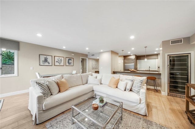 247 Calliope St, Laguna Beach, CA 92651 - living area featuring beverage cooler, baseboards, recessed lighting, and light wood-style floors