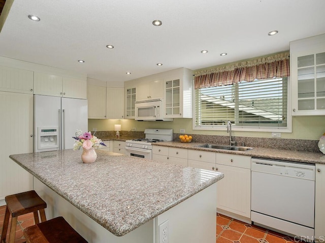 950 E Elder St, Fallbrook, CA 92028 - kitchen with white appliances, a sink, recessed lighting, a center island, and white cabinetry