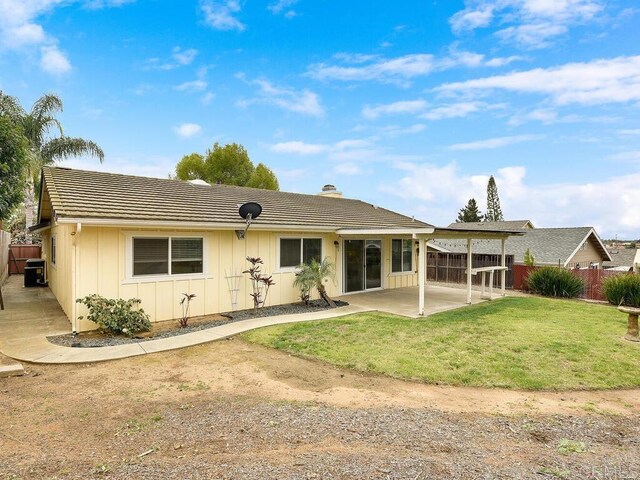 950 E Elder St, Fallbrook, CA 92028 - back of house with board and batten siding, a chimney, a patio, and a tiled roof