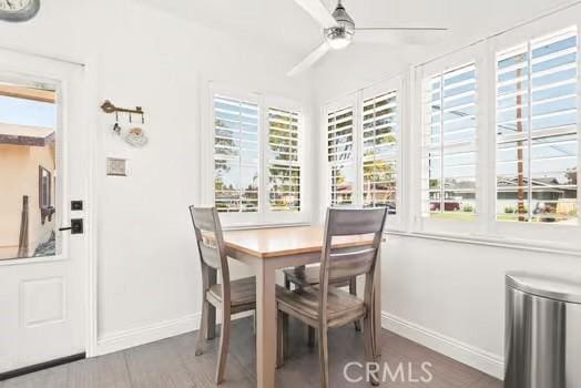 dining area with baseboards, ceiling fan, and a wealth of natural light