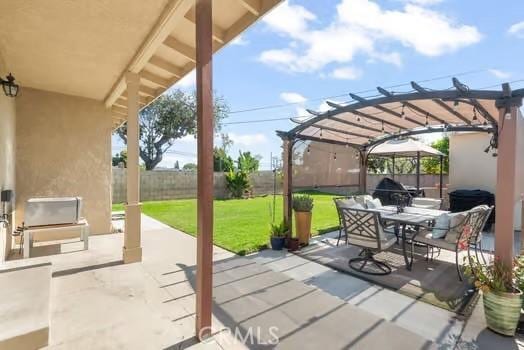 view of patio / terrace with a pergola, outdoor dining space, and fence