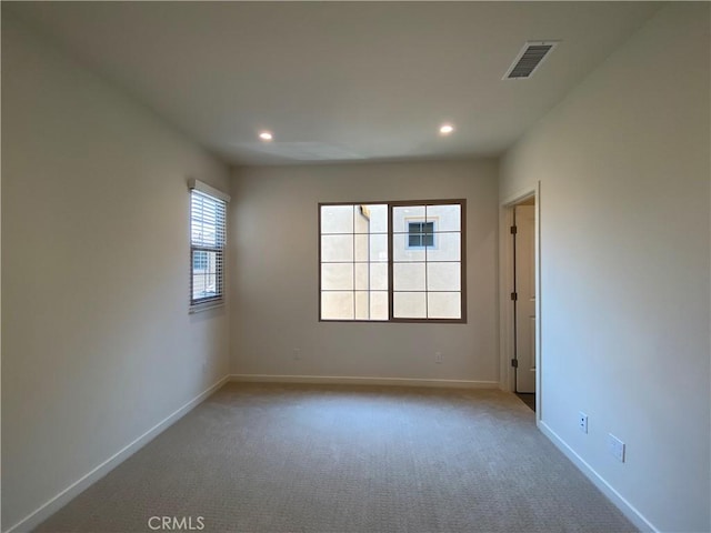 carpeted spare room with baseboards, visible vents, and recessed lighting