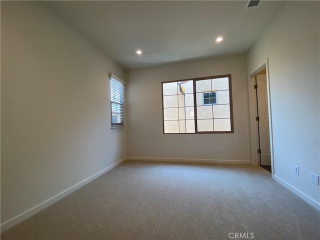 empty room with baseboards, carpet floors, and recessed lighting