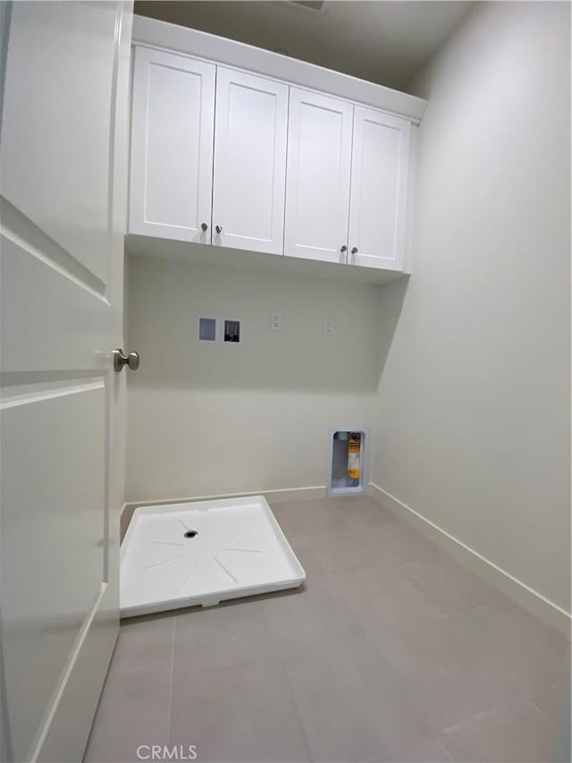 laundry room featuring baseboards, cabinet space, hookup for a gas dryer, and hookup for a washing machine
