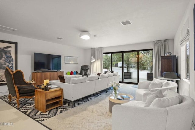 living room featuring visible vents and plenty of natural light