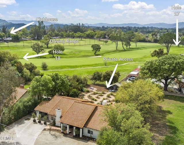 bird's eye view with a mountain view and view of golf course