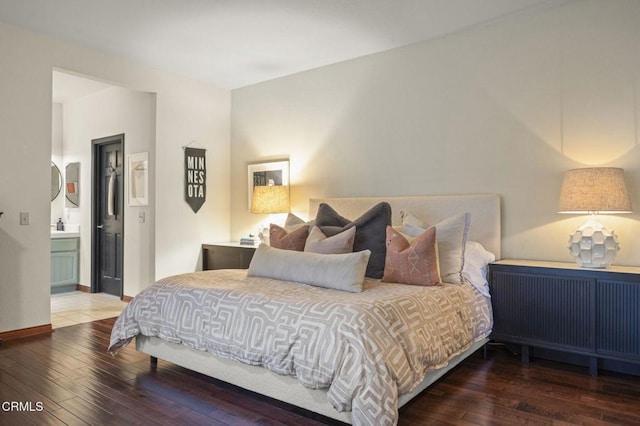 bedroom featuring hardwood / wood-style floors and ensuite bath