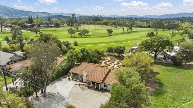 bird's eye view with view of golf course and a mountain view