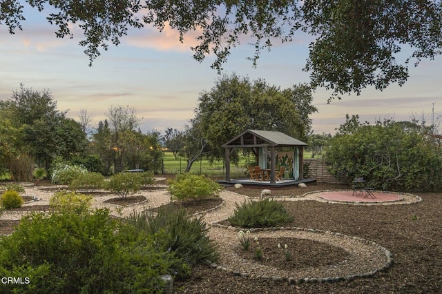 view of community with fence, a gazebo, and a patio