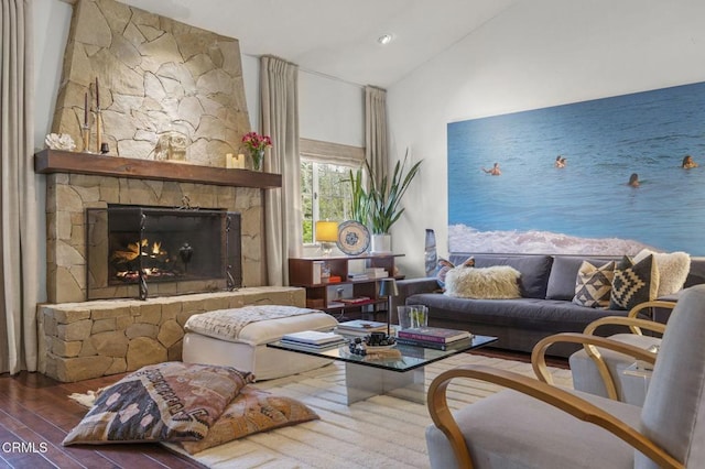 living area with hardwood / wood-style floors, a fireplace, and lofted ceiling
