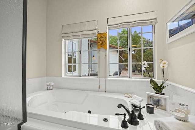 bathroom with a tub with jets