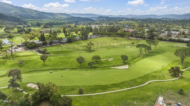 aerial view featuring a mountain view and golf course view