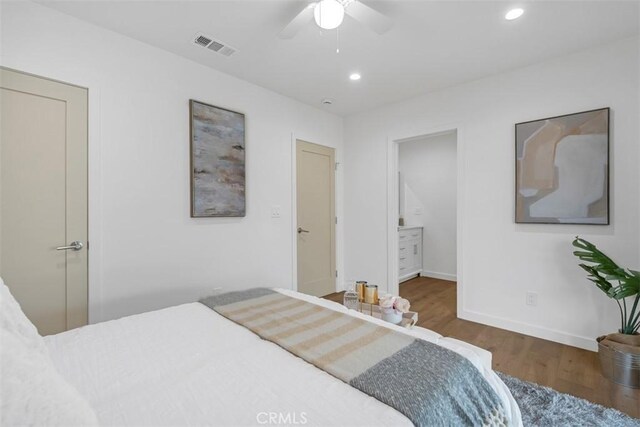 bedroom with visible vents, recessed lighting, baseboards, and wood finished floors