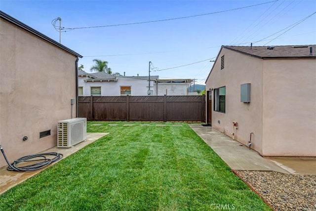 view of yard with a fenced backyard and ac unit