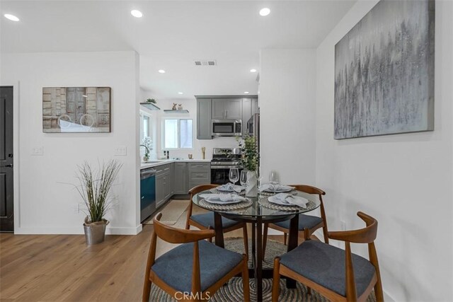 dining area featuring recessed lighting, baseboards, light wood finished floors, and visible vents