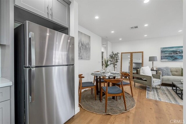 dining space featuring visible vents, recessed lighting, and light wood-type flooring