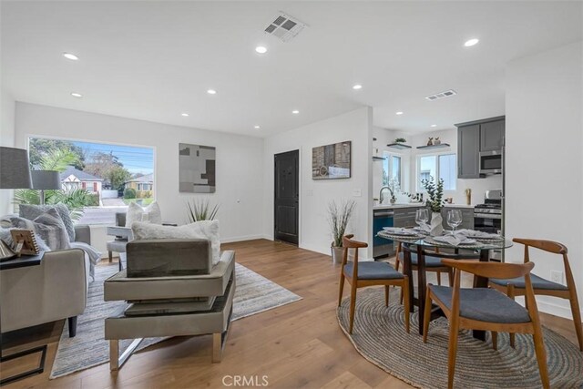 living area with a wealth of natural light, recessed lighting, and visible vents