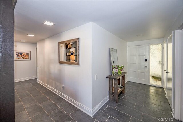 hall featuring baseboards