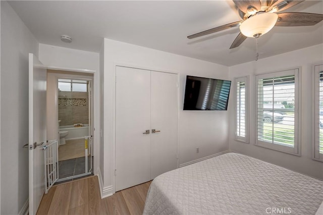 bedroom featuring a closet, ceiling fan, and light wood finished floors