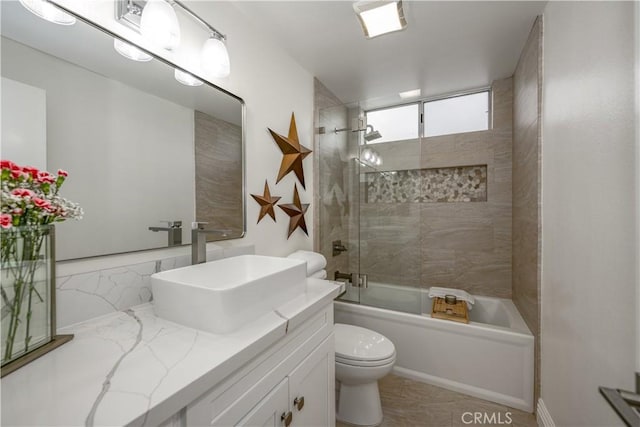 full bathroom with toilet, vanity, and shower / bath combination