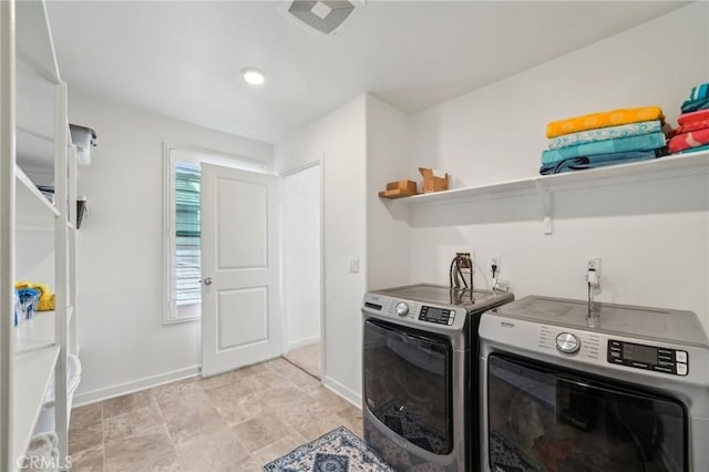 laundry area with washer and clothes dryer, laundry area, and baseboards