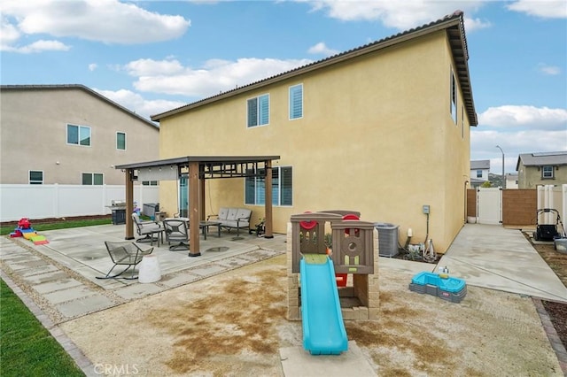 back of house with stucco siding, fence, and a patio area