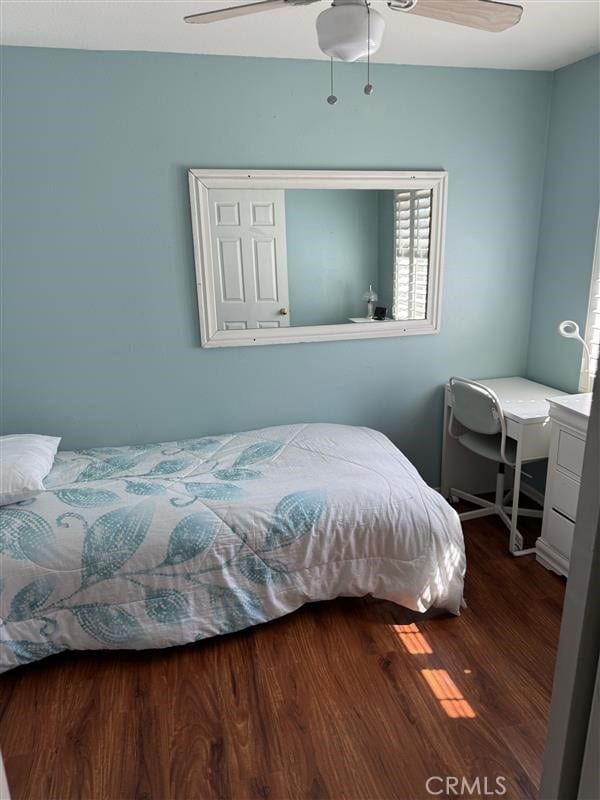 bedroom with ceiling fan and wood finished floors
