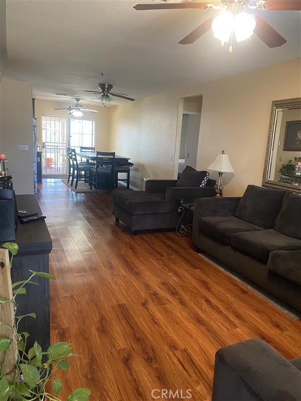 living room featuring wood finished floors and ceiling fan