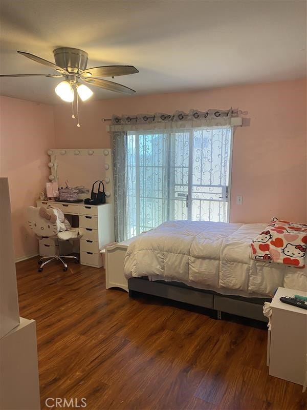 bedroom with a ceiling fan and wood finished floors