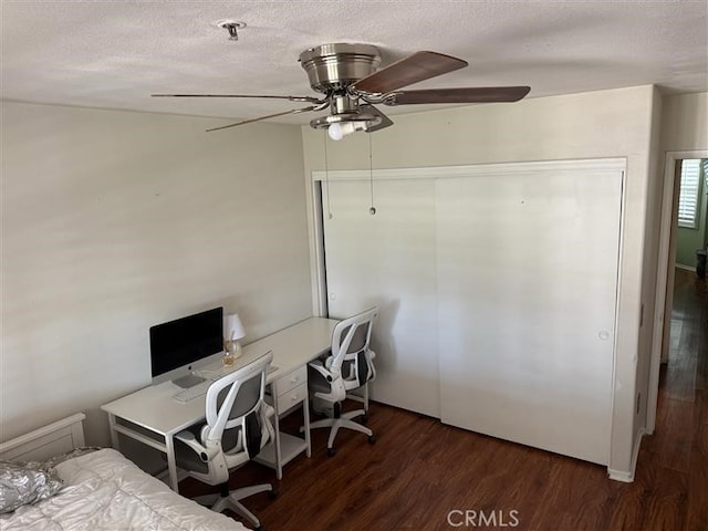 bedroom featuring a textured ceiling, a closet, ceiling fan, and wood finished floors