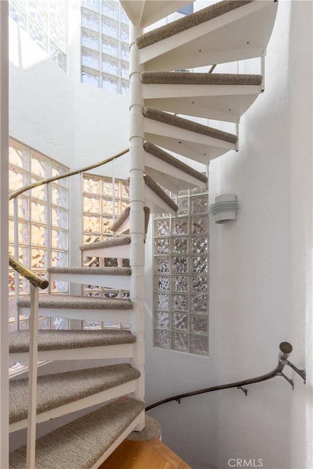 staircase featuring a towering ceiling