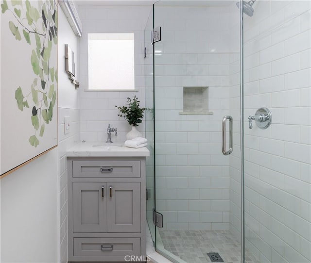 full bathroom with vanity and a shower stall