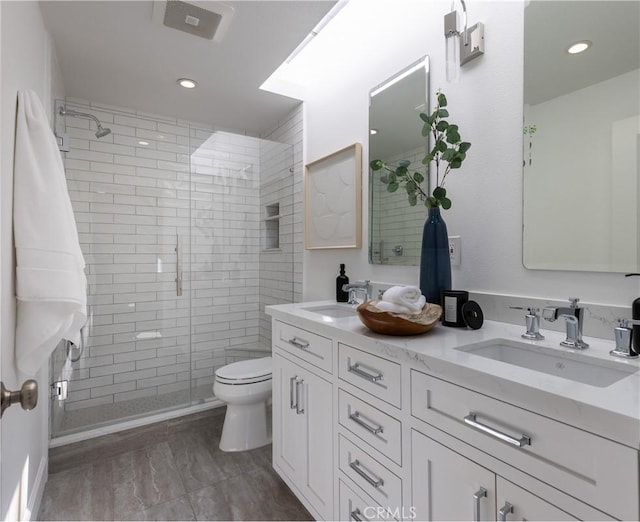 full bath featuring visible vents, a sink, a stall shower, and toilet