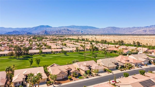 drone / aerial view with a mountain view, view of golf course, and a residential view