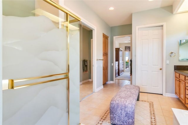 full bath with baseboards, recessed lighting, tile patterned flooring, and vanity