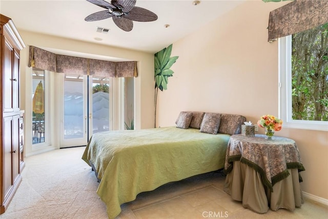 bedroom featuring light carpet, multiple windows, access to exterior, and visible vents