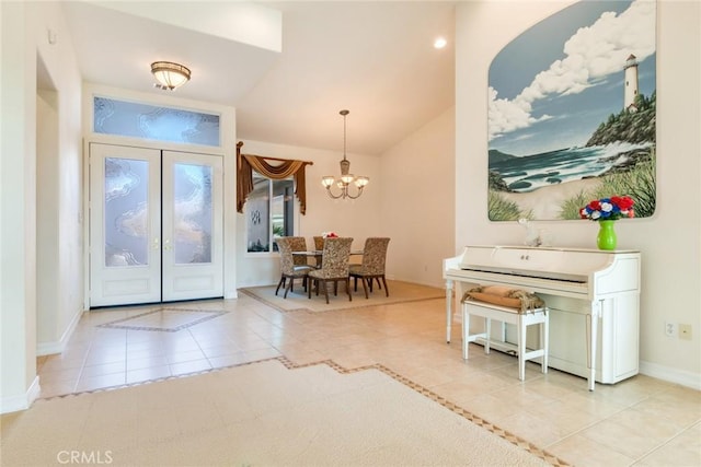 foyer with lofted ceiling, an inviting chandelier, light tile patterned floors, french doors, and baseboards