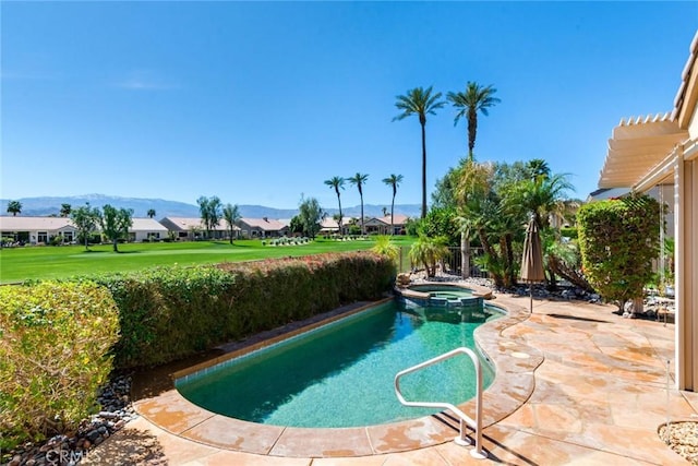 view of pool featuring a residential view, a pool with connected hot tub, a mountain view, and a patio
