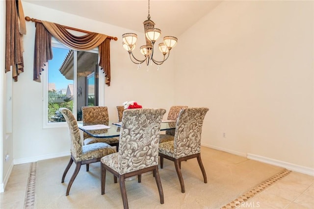 dining area with light tile patterned flooring, baseboards, and a chandelier