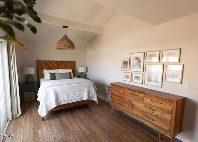 bedroom with lofted ceiling with beams and wood finished floors