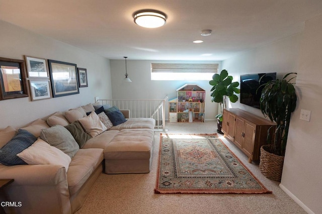 carpeted living room with baseboards