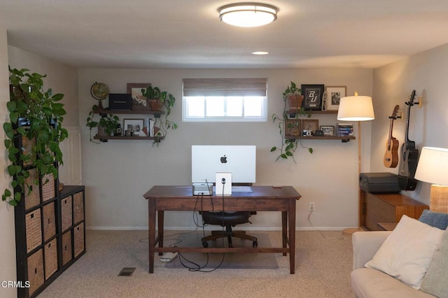 carpeted office space with baseboards and visible vents