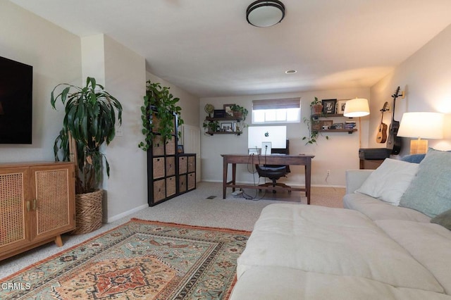carpeted living room featuring baseboards
