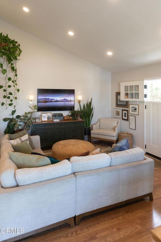 living room featuring lofted ceiling, wood finished floors, and recessed lighting