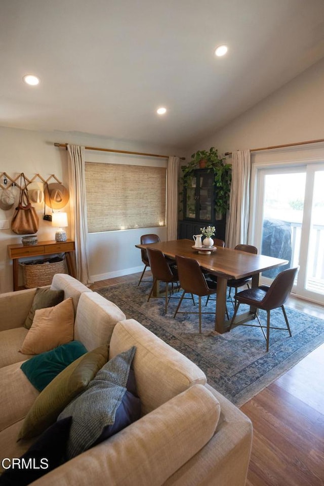 dining space featuring recessed lighting, lofted ceiling, and wood finished floors