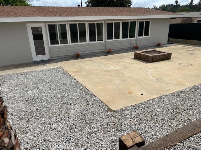 1197 Colony Dr, Pomona, CA 91766 - back of house featuring a patio area, a shingled roof, a fire pit, and stucco siding