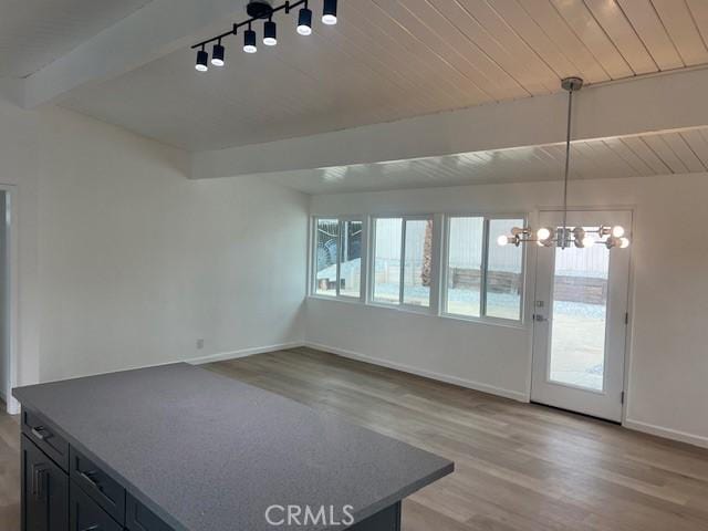 1197 Colony Dr, Pomona, CA 91766 - unfurnished dining area with plenty of natural light, light wood-style floors, an inviting chandelier, and beam ceiling